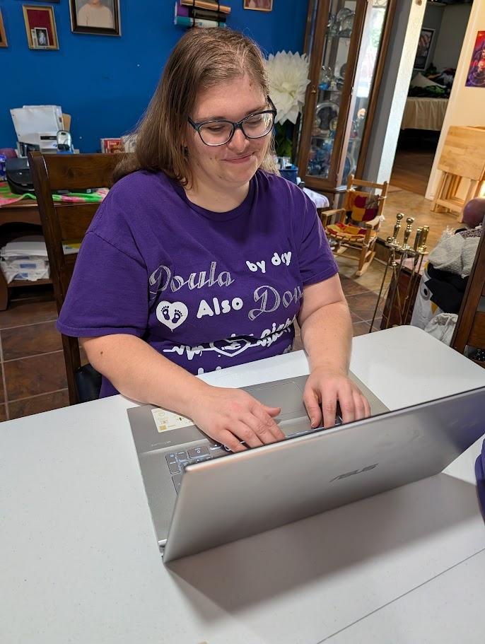Melanie Powell working on a laptop